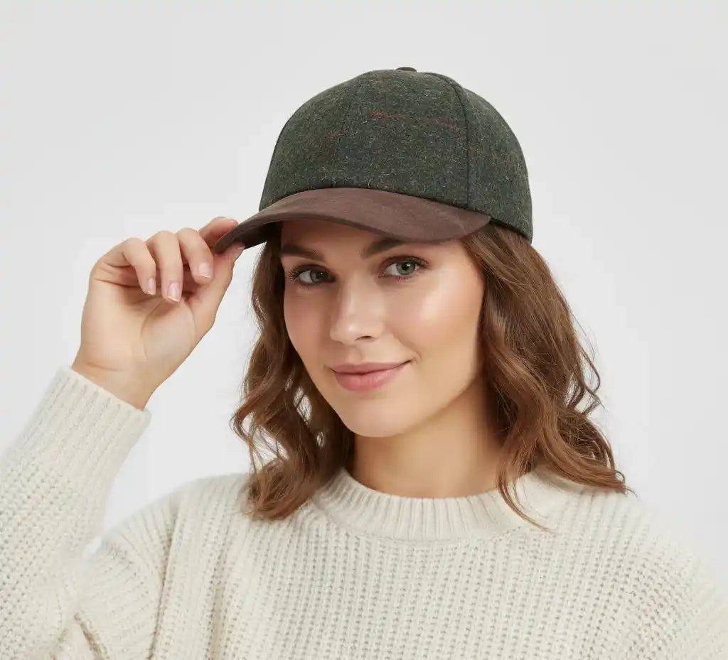 This Checked Tweed Suede Baseball Cap by Novella Hats brings a stylish, heritage-inspired twist to your everyday wardrobe. Designed with a brown suede-effect peak and button top, it offers a refined look while keeping the classic six-panel baseball cap shape.