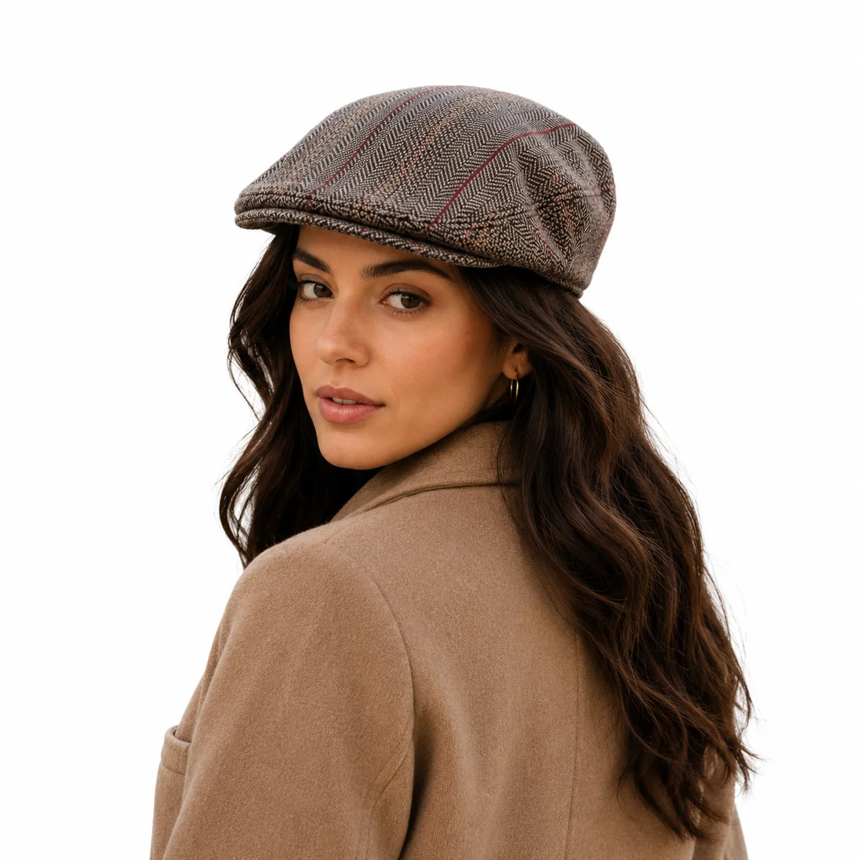 Woman wearing a brown tweed cap and beige coat on a white background